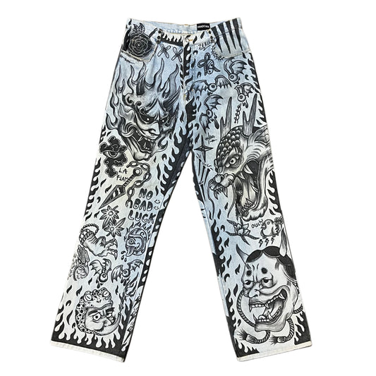 Pants with black and white tattoo-style designs on a white background