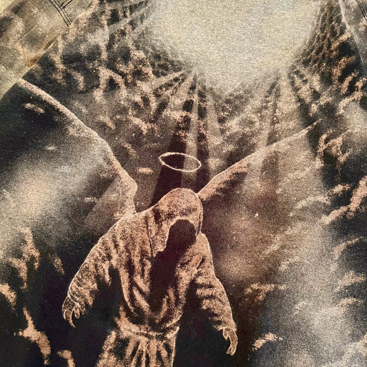 A sepia-toned artwork showing a hooded robed figure with a halo, set against a dramatic cloudy sky with rays of light.