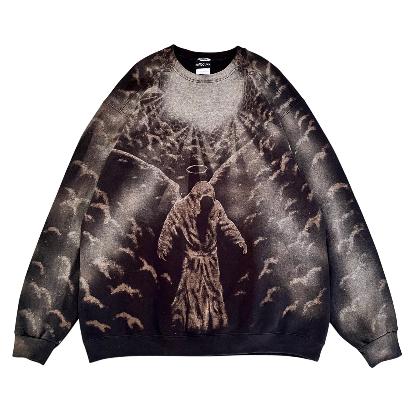 A custom bleached art crewneck sweatshirt featuring a dark, gothic graphic print of a hooded angel with wings and a halo surrounded by numerous bats in a smoky, dark sky. The sweatshirt has a faded, washed-out effect across the sleeves and body, fading from dark gray to black.
