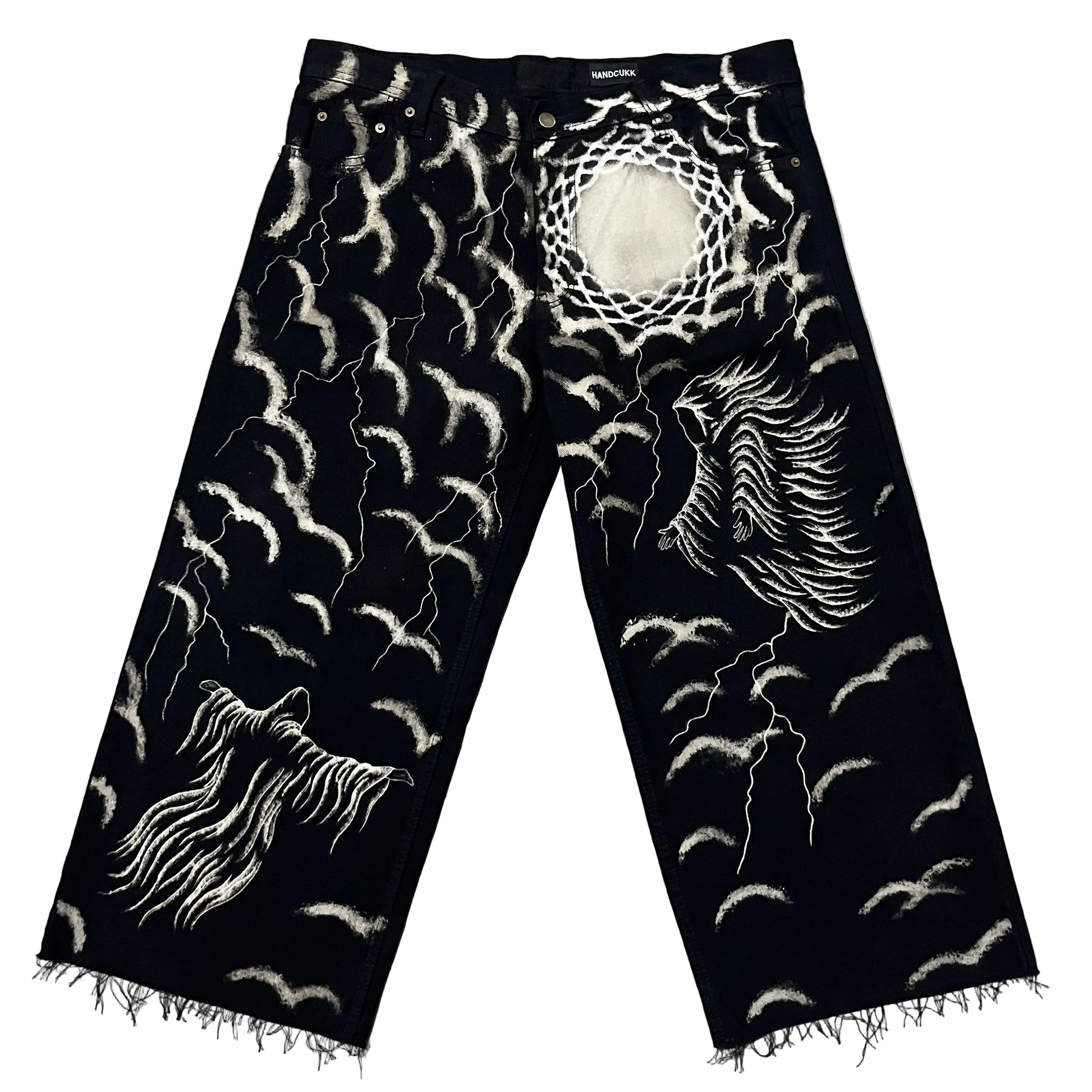 Black denim jeans with classic dark art designs, including a large winged figure on one leg, a ghostly figure on the other, and numerous lightning bolts and sky’s.