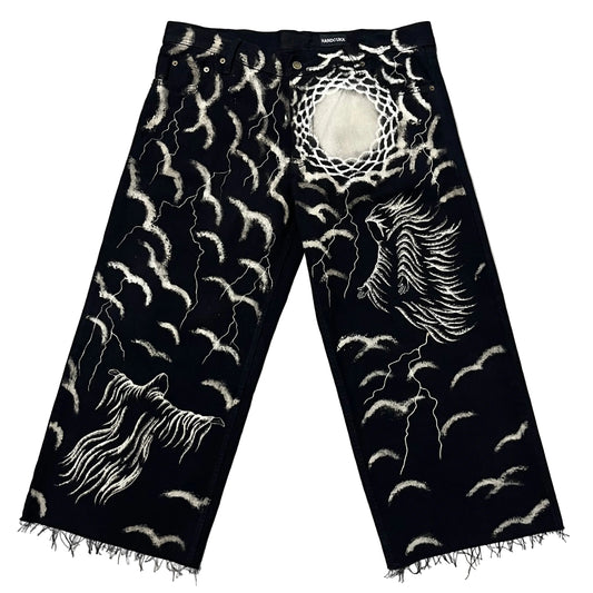 Black denim jeans with classic dark art designs, including a large winged figure on one leg, a ghostly figure on the other, and numerous lightning bolts and sky’s.
